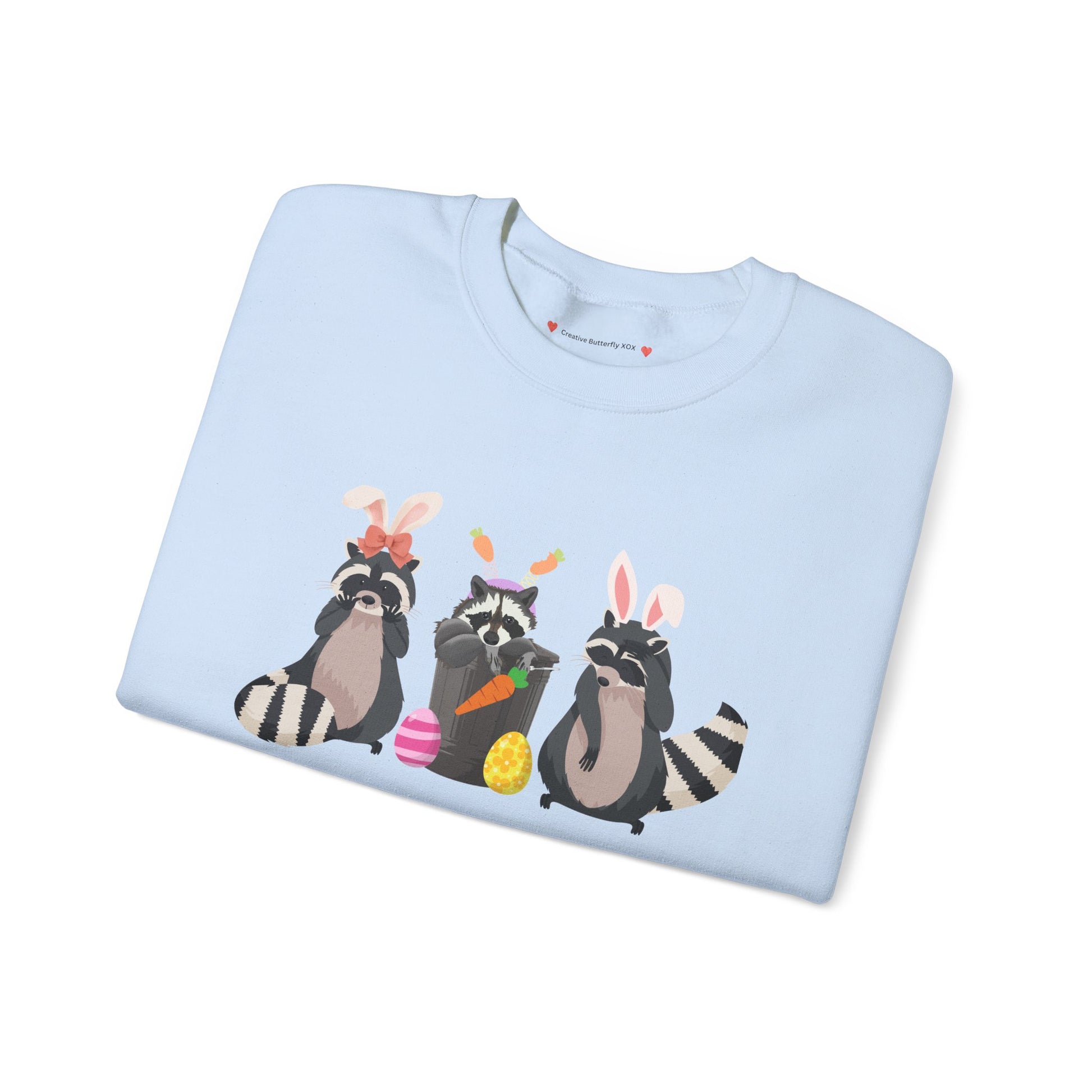 Cozy Easter bunny sweatshirt featuring adorable raccoons and soft pastels - Easter sweater pullover - color light blue close up