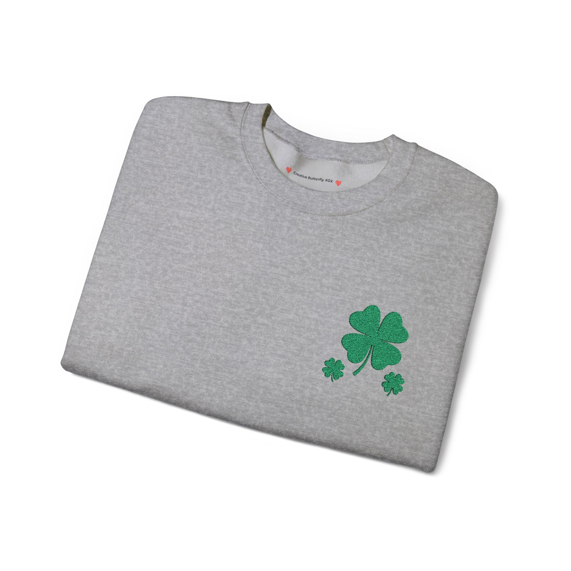 Grey folded sweatshirt view - St. Paddy’s Day pullover sweatshirt with a simple four-leaf clover design