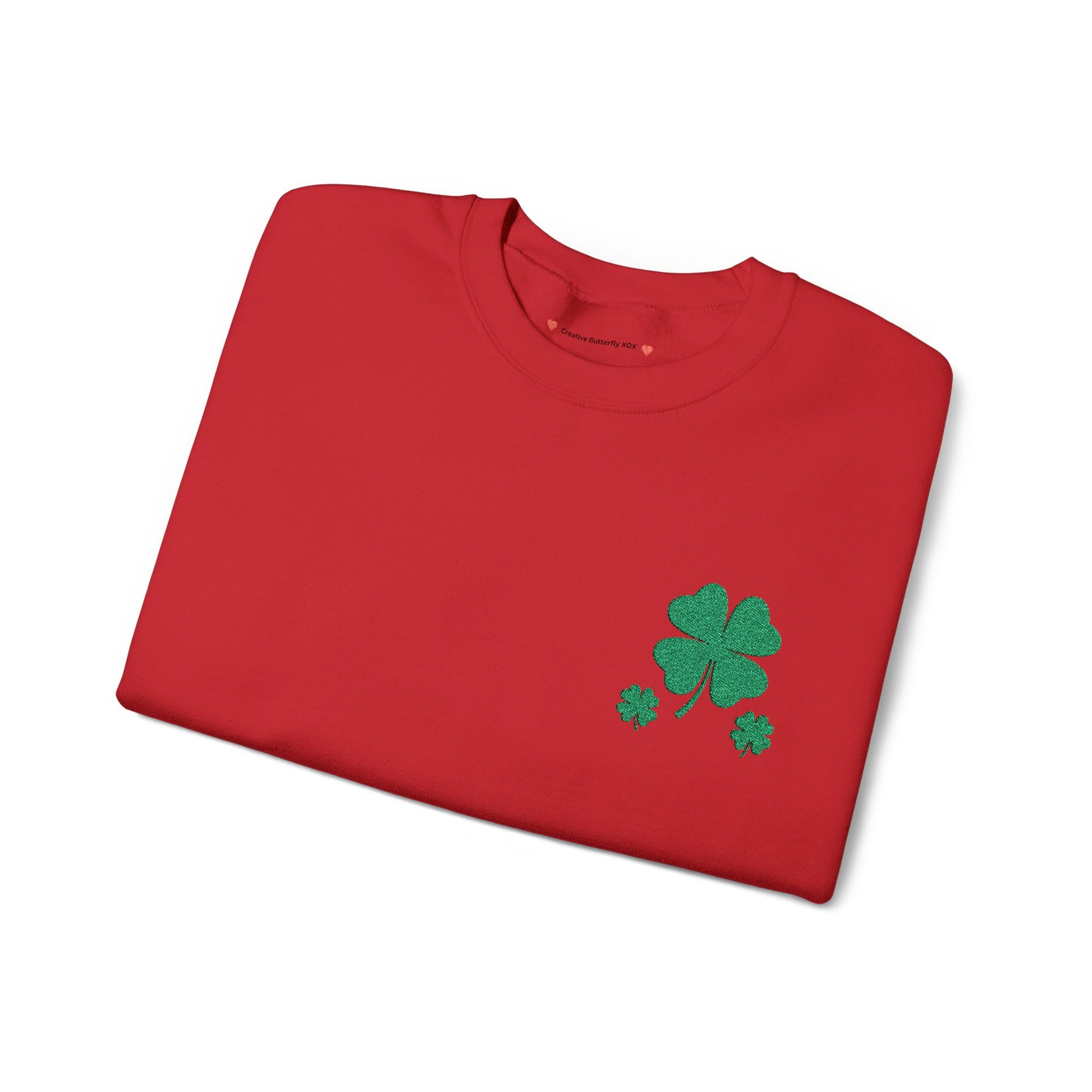 Red folded sweatshirt view - St. Paddy’s Day pullover sweatshirt, St. Patrick's day shirt with a simple four-leaf clover design sweater