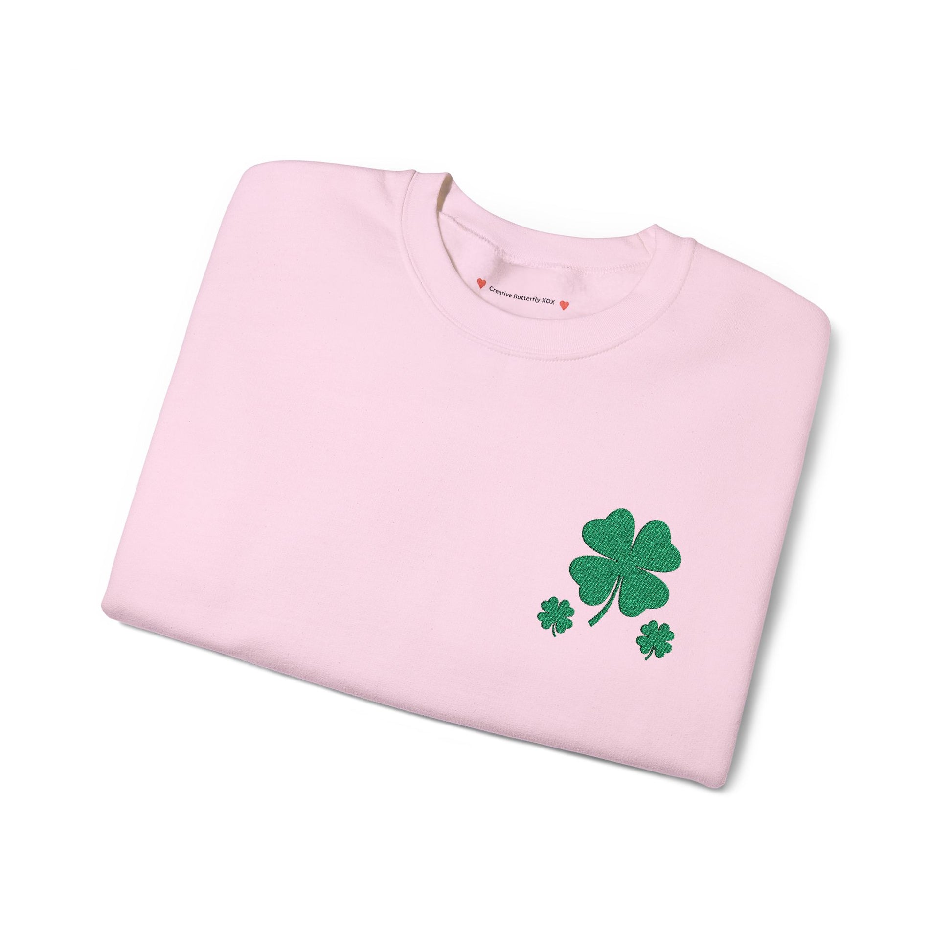 light pink folded sweatshirt view - St. Paddy’s Day pullover sweatshirt with a simple four-leaf clover design sweater