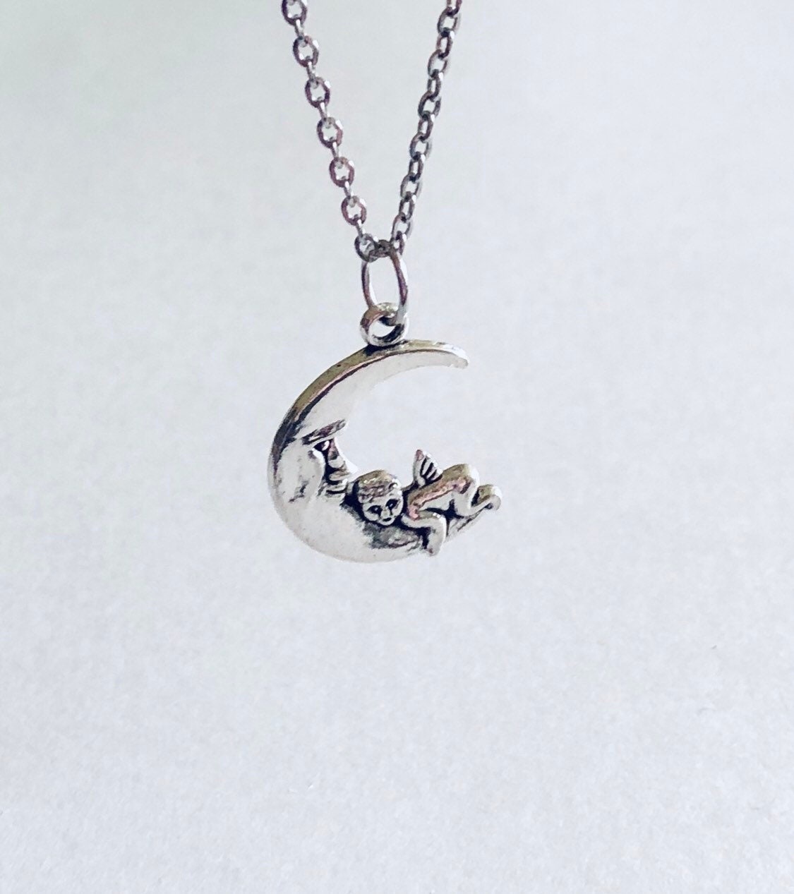 Silver Cherub Moon Necklace, Dainty Chain with Angel Charm on Crescent Moon Celestial Wicca Witchy Woman